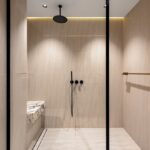 Sleek walk-in shower with light wood textures and modern fixtures.
